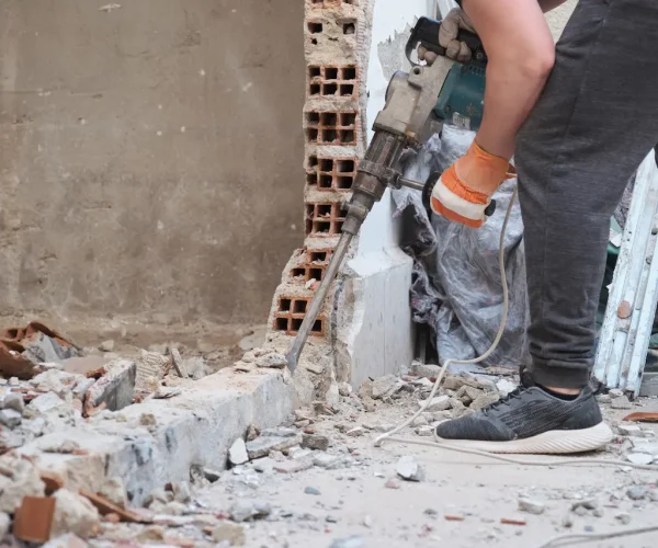 unrecognizable-man-using-a-jackhammer-to-drill-int-2026-01-08-07-47-56-utc