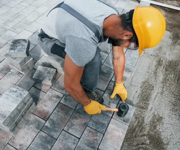 uses-a-rubber-hammer-male-worker-in-yellow-colore-2026-03-24-06-26-47-utc